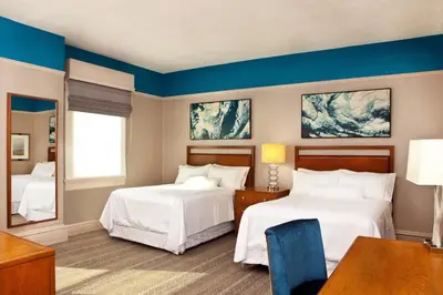 a hotel room with two beds and a table at The Westin Great Southern Columbus in Columbus