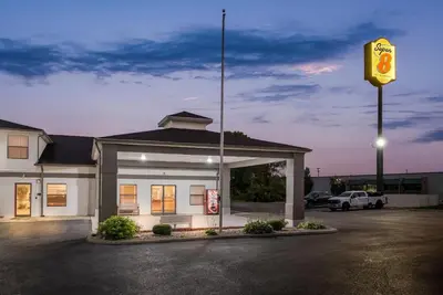 a gas station with a sign in a parking lot at Super 8 by Wyndham Bellefontaine in Bellefontaine