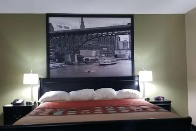 a large picture of a bridge above a bed at Super 8 by Wyndham Bellefontaine in Bellefontaine