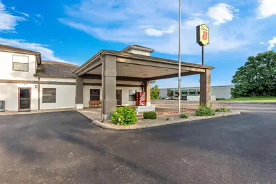 a gas station with a pdq sign in a parking lot at Super 8 by Wyndham Bellefontaine in Bellefontaine