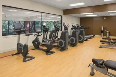 a gym with treadmills and elliptical machines at Sheraton Suites Akron Cuyahoga Falls in Cuyahoga Falls