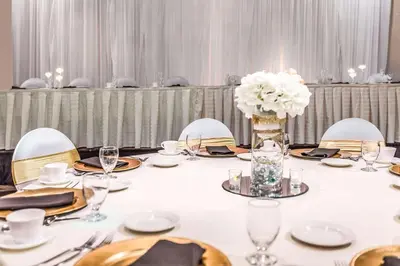 a long table with chairs and a vase of white flowers at Quality Inn & Suites Richfield in Richfield