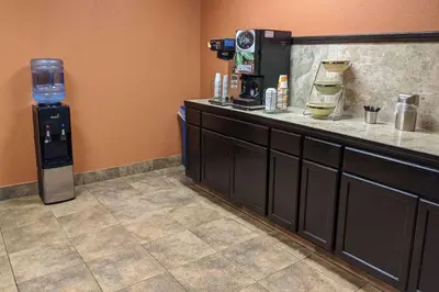 a coffee shop with a counter with a water dispenser at Quality Inn & Suites Richfield in Richfield
