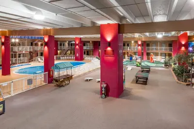 a large indoor swimming pool in a building with red columns at Quality Inn & Suites Richfield in Richfield