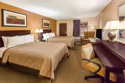 a hotel room with two beds and a desk at Quality Inn & Suites Richfield in Richfield