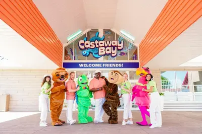 a group of people dressed in costumes standing in front of a sign at Castaway Bay by Cedar Point Resorts in Sandusky
