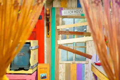 a room with a wooden door and a television at Castaway Bay by Cedar Point Resorts in Sandusky