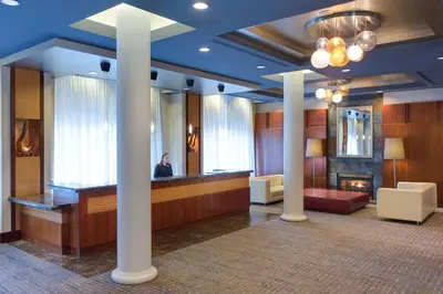 a man sitting at a reception desk in a hotel lobby at Hyatt Regency Cleveland at The Arcade in Cleveland