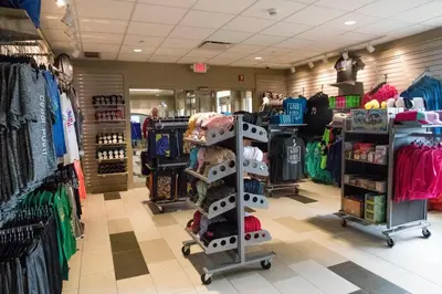 a clothing store with a rack of clothes at Cedar Point's Express Hotel in Sandusky