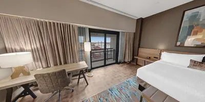 a hotel room with a bed and a desk and a window at Hilton Garden Inn Toledo Downtown in Toledo
