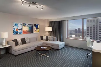 a living room with a couch and a large window at Hyatt Regency Cincinnati in Cincinnati