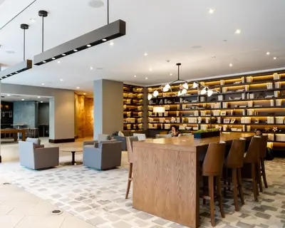 a lobby with a library with a bar and chairs at Hyatt Regency Cincinnati in Cincinnati