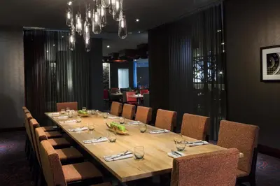 a long wooden table with chairs in a restaurant at Hyatt Regency Cincinnati in Cincinnati