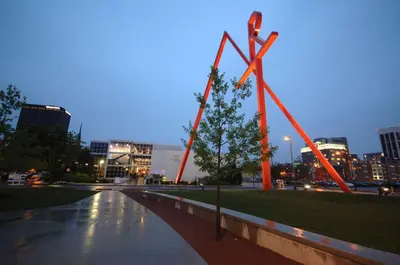 a large orange sculpture in a city at night at Hyatt Regency Columbus in Columbus