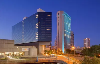 a city skyline with two tall buildings at night at Hyatt Regency Columbus in Columbus