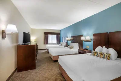 a hotel room with two beds and a flat screen tv at Best Western Port Clinton in Port Clinton