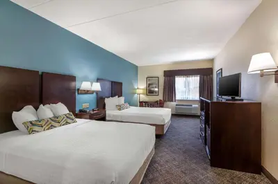 a hotel room with two beds and a flat screen tv at Best Western Port Clinton in Port Clinton