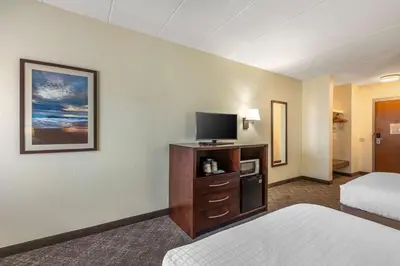 a hotel room with a bed and a flat screen tv at Best Western Port Clinton in Port Clinton