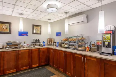 a kitchen with wooden cabinets and a counter top at Best Western Port Clinton in Port Clinton