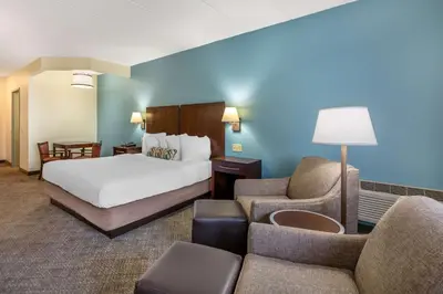 a hotel room with a bed and a couch at Best Western Port Clinton in Port Clinton