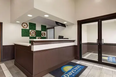 a waiting area of a barber shop with a mirror at Days Inn by Wyndham Hillsboro in Hillsboro