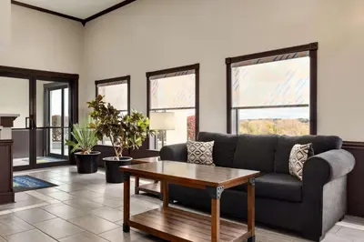 a living room with a couch and a table at Days Inn by Wyndham Hillsboro in Hillsboro
