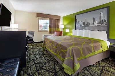 a hotel room with a bed and a desk at Super 8 by Wyndham Wooster in Wooster