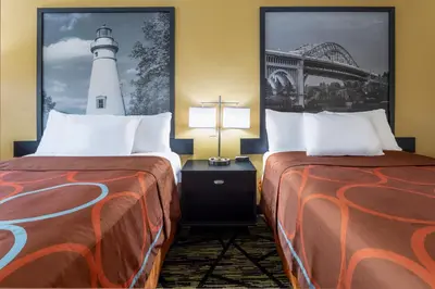 a hotel room with two beds and a lighthouse at Super 8 by Wyndham Wooster in Wooster