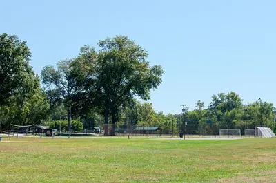 a park with a tennis court and a tennis court at Super 8 by Wyndham Ripley in Ripley
