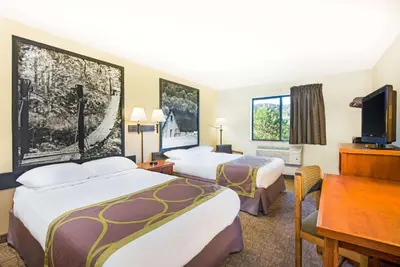 a hotel room with two beds and a desk at Super 8 by Wyndham Ripley in Ripley