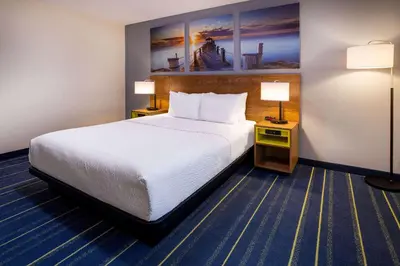 a hotel room with a bed and two lamps at Days Inn by Wyndham Grayson in Grayson