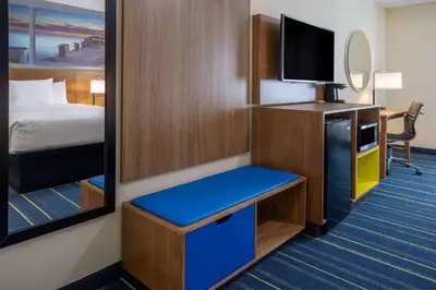 a small room with a bed and a television at Days Inn by Wyndham Grayson in Grayson