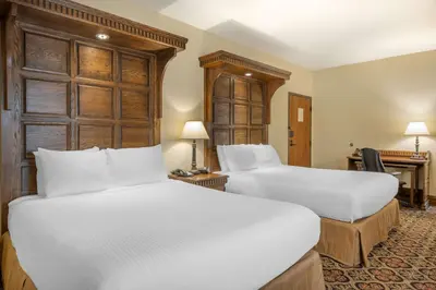 a hotel room with two beds and a desk at Best Western Premier Mariemont Inn in Cincinnati