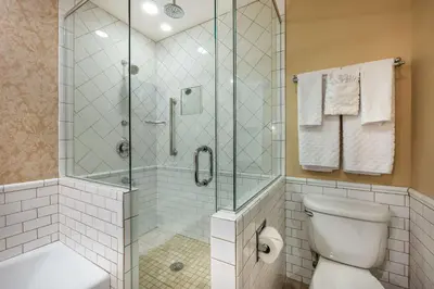 a bathroom with a shower and a toilet at Best Western Premier Mariemont Inn in Cincinnati
