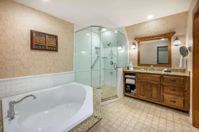 a bathroom with a tub and a shower and a sink at Best Western Premier Mariemont Inn in Cincinnati
