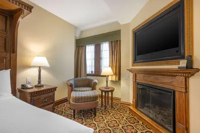 a hotel room with a fireplace and a flat screen tv at Best Western Premier Mariemont Inn in Cincinnati