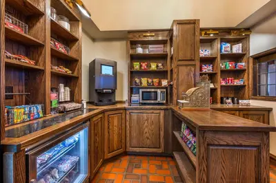 a kitchen with a refrigerator and a tv at Best Western Premier Mariemont Inn in Cincinnati