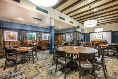 a dining room with wooden tables and chairs at Best Western Premier Mariemont Inn in Cincinnati