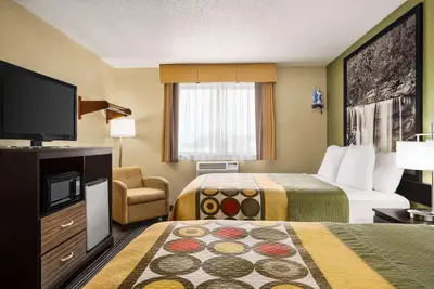 a hotel room with two beds and a flat screen tv at Super 8 by Wyndham Maysville KY in Maysville