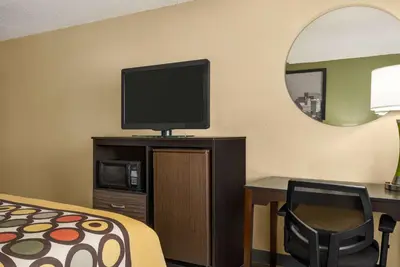 a hotel room with a bed and a flat screen tv at Super 8 by Wyndham Maysville KY in Maysville