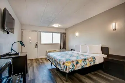 a hotel room with a bed and a television at Motel 6 Columbus OH - OSU North in Columbus