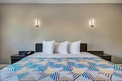 a bed in a hotel room with a colorful bedspread at Motel 6 Columbus OH - OSU North in Columbus