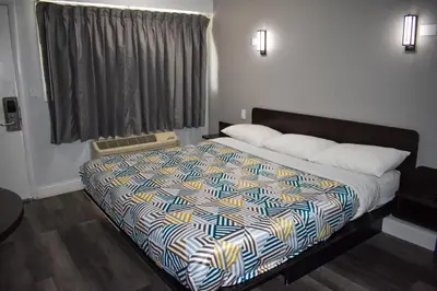 a bedroom with a bed with a colorful comforter at Motel 6 Columbus OH - OSU North in Columbus