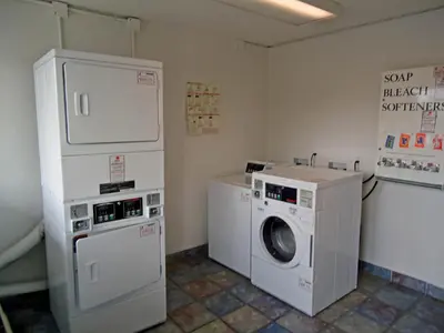 a laundry room with a washing machine and a washer at Motel 6 Columbus OH - OSU North in Columbus