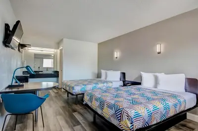 a hotel room with two beds and a table at Motel 6 Columbus OH - OSU North in Columbus