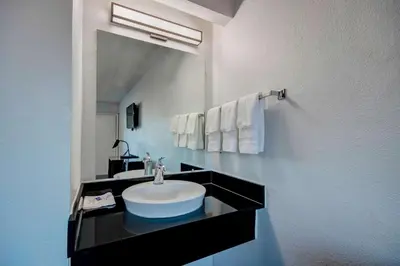 a bathroom with a sink and a large mirror at Motel 6 Columbus OH - OSU North in Columbus