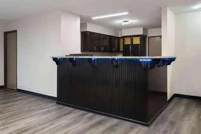 a bar in the middle of a room at Super 8 by Wyndham Mt. Vernon in Mount Vernon