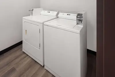 two washing machines and a washer and dryer in a room at Super 8 by Wyndham Mt. Vernon in Mount Vernon
