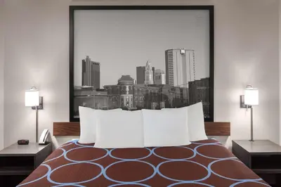 a bed with white pillows in a hotel room at Super 8 by Wyndham Mt. Vernon in Mount Vernon
