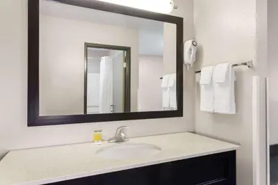 a bathroom with a sink and a mirror at Super 8 by Wyndham Mt. Vernon in Mount Vernon